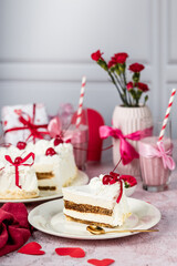heart-shaped tiramisu cake with white cream in a cut on a white plate, cocktail cherry, red ribbons, Valentine's Day cake, tiramisu with cherry, mousse cake, birthday sweets