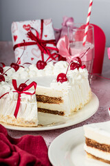 heart-shaped tiramisu cake with white cream in a cut on a white plate, cocktail cherry, red ribbons, Valentine's Day cake, tiramisu with cherry, mousse cake, birthday sweets