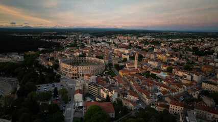 Obraz premium Flying above historic city of Pula , historic Roman amphitheatre of Pula aerial view, tourism in Croatia