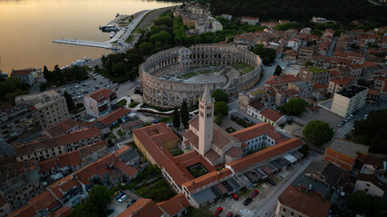 Fototapeta premium Flying above historic city of Pula , historic Roman amphitheatre of Pula aerial view, tourism in Croatia