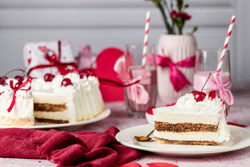 heart-shaped tiramisu cake with white cream in a cut on a white plate, cocktail cherry, red ribbons, Valentine's Day cake, tiramisu with cherry, mousse cake, birthday sweets