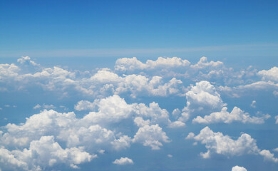White clouds floating in the sky view from airplane while flying over the sea of clouds