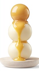 Creamy sauce drizzled over three white spheres on a plate. Dessert, food photography, sweet treat