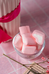 pink marshmallows in the shape of a heart on a festive table, Birthday, Valentine's Day, pink tablecloth on the table, marshmallows, ribbons, light background, still life, preparation for the holiday