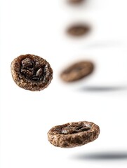 Obraz premium Chocolate cereal pieces falling, white background, breakfast food, advertising