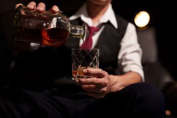 Businessman sitting Holding a Glass of Whiskey Drink drinking whiskey 