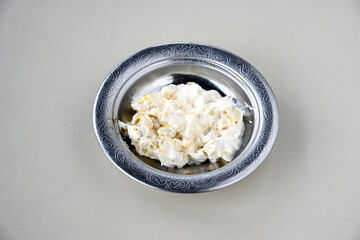 Close up turkish traditional hot spicy appetizer Atom ingredients with aubergine, yogurt and cooked oily hot pepper sauce.. Kozpatlican yogurt, manco meze.