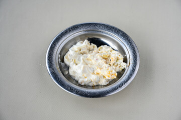 Close up turkish traditional hot spicy appetizer Atom ingredients with aubergine, yogurt and cooked oily hot pepper sauce.. Kozpatlican yogurt, manco meze.