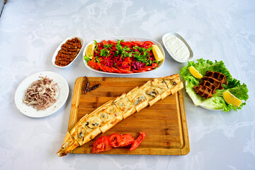 Kiymali pide.Turkish pide with minced meat. Turkish pizza mince pita Pide on white . Etli ekmek.Kusbasi kasarli, kiymali kasarli, kiymali yumurtali, Bafra, Trabzon, Kusbasili pide. Urfa acili lahmacun