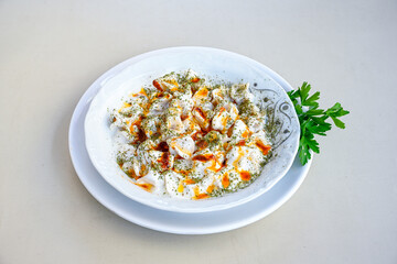 Manti Turkish Ravioli Kayseri with yogurt and chili sauce.