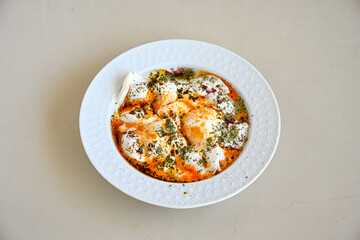 Manti Turkish Ravioli Kayseri with yogurt and chili sauce.