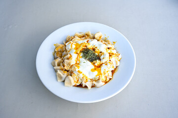 Manti Turkish Ravioli Kayseri with yogurt and chili sauce.