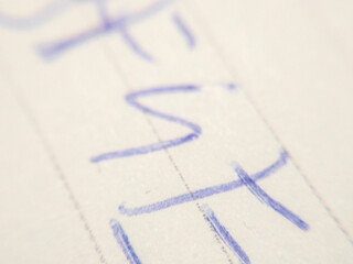 Close-up of handwritten letters with blue ink on white paper, showcasing artistic expression and creativity. Ideal for concepts of writing and communication.