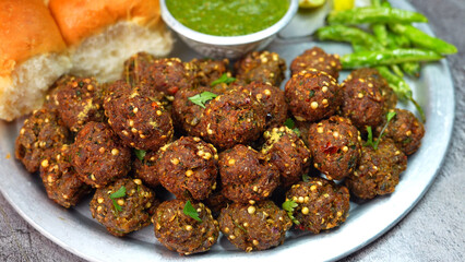 Meat balls, Kebab on a silver plate with soft buns, vibrant red and green sauce, and crispy fried chilies. A popular dish in Middle Eastern, South Asian, and North African, Ramadan and Eid. 
