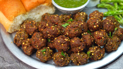 Meat balls, Kebab on a silver plate with soft buns, vibrant red and green sauce, and crispy fried chilies. A popular dish in Middle Eastern, South Asian, and North African, Ramadan and Eid. 