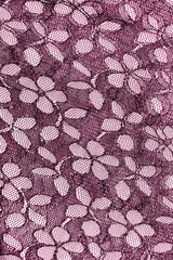 pink floral pattern on guipure fabric.  wallpaper in modern design.   pink textile texture.