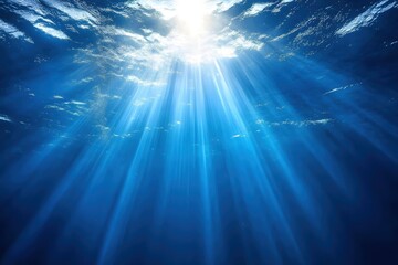 Fototapeta premium Underwater Sunlight Rays Shining Through the Ocean Surface Creating a Serene Atmosphere