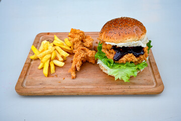 Big tasty burger with beef cutlet on a plate. Hamburger, cheeseburger with mushroom. Hamburger, Mexica, mushroom double burger.  Crispy chicken burger. With french fries, patates kizartmasi.