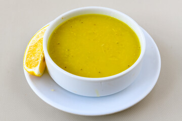 Lentil ( mercimek corbasi ) soup with melted butter and red pepper sauce. Limon ve soslu mercimek corba.