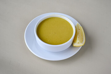 Lentil ( mercimek corbasi ) soup with melted butter and red pepper sauce. Limon ve soslu mercimek corba.