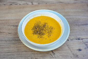 Lentil ( mercimek corbasi ) soup with melted butter and red pepper sauce. Limon ve soslu mercimek corba.