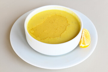 Lentil ( mercimek corbasi ) soup with melted butter and red pepper sauce. Limon ve soslu mercimek corba.