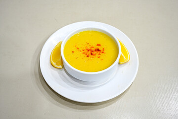 Lentil ( mercimek corbasi ) soup with melted butter and red pepper sauce. Limon ve soslu mercimek corba.