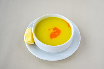 Lentil ( mercimek corbasi ) soup with melted butter and red pepper sauce. Limon ve soslu mercimek corba.