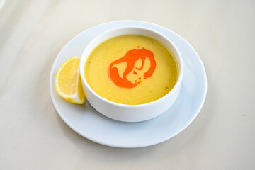 Lentil ( mercimek corbasi ) soup with melted butter and red pepper sauce. Limon ve soslu mercimek corba.