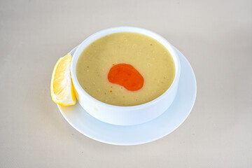 Lentil ( mercimek corbasi ) soup with melted butter and red pepper sauce. Limon ve soslu mercimek corba.