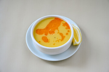 Lentil ( mercimek corbasi ) soup with melted butter and red pepper sauce. Limon ve soslu mercimek corba.