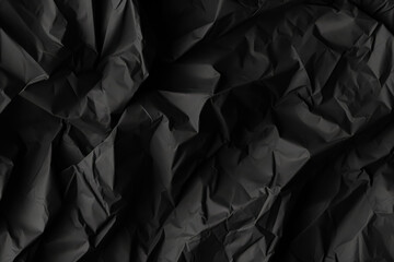Obraz premium Black piece of paper with a jagged edge. The paper is crumpled and torn, giving it a rough and unkempt appearance. Concept of chaos and disorder