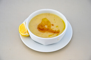 Lentil ( mercimek corbasi ) soup with melted butter and red pepper sauce. Limon ve soslu mercimek corba.