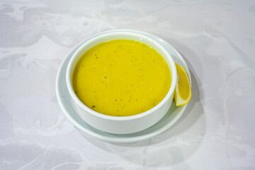 Lentil ( mercimek corbasi ) soup with melted butter and red pepper sauce. Limon ve soslu mercimek corba.
