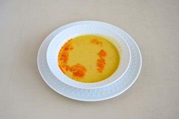 Lentil ( mercimek corbasi ) soup with melted butter and red pepper sauce. Limon ve soslu mercimek corba.
