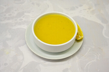 Lentil ( mercimek corbasi ) soup with melted butter and red pepper sauce. Limon ve soslu mercimek corba.