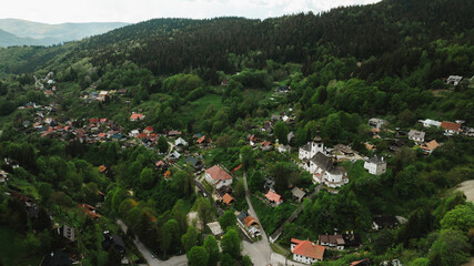 Beautiful aerial countryside landscape in Spania Dolina village, Slovakia. Old mining village. Historic church in Spania dolina. Summer rural lanscape in Slovakian mountains. © Robbie Smith 1 