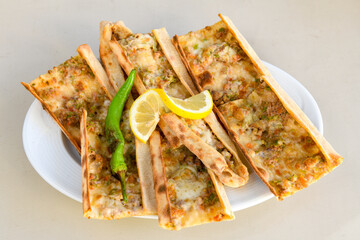 Kiymali pide.Turkish pide with minced meat. Turkish pizza mince pita Pide on white . Etli ekmek.Kusbasi kasarli, kiymali kasarli, kiymali yumurtali, Bafra, Trabzon, Kusbasili pide. Urfa acili lahmacun