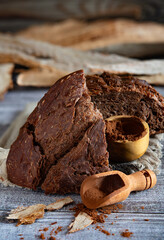 Sliced cocoa bread with cocoa powder on rustic wooden table