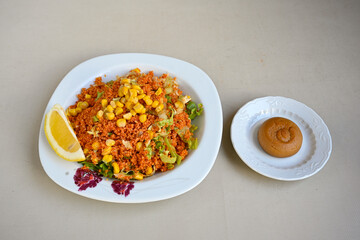 Traditional turkish bulgur pilaf with tomato sause in plate (Turkish name; bulgur pilavi, meyhane pilavi) Pirinc pilavi. Pilavustu tavuk, nohut, kuru fasulye, ciger.