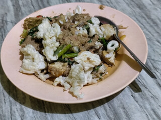 Rujak Cingur. Traditional Javanese food consisting of lontong with vegetables, peanut sauce, petis, tempeh, tofu, beef tongue, and crackers.	