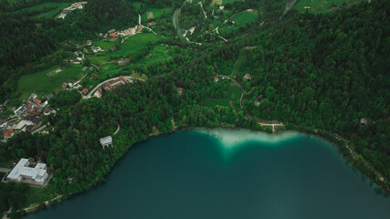 Aerial view of Church of the Assumption of Mary in the center of the lake Bled. Flying around small...