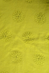 bright yellow floral background. texture of yellow fabric with floral embroidered ornament.