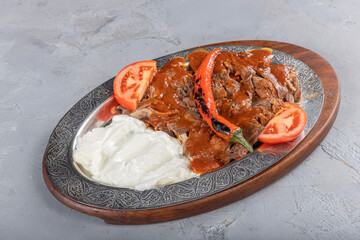 Iskender kebab, also known as Bursa kebab, is a popular Turkish dish. It consists of thinly sliced...
