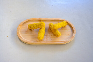 Delicious crispy cheese sticks with mozzarella, salt and spices, breaded and fried in oil. Fast food, takeaway