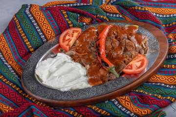 Iskender kebab, also known as Bursa kebab, is a popular Turkish dish. It consists of thinly sliced...