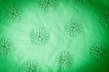 green floral background. texture of green fabric with floral embroidered ornament.