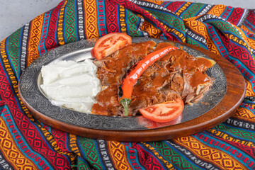 Iskender kebab, also known as Bursa kebab, is a popular Turkish dish. It consists of thinly sliced...