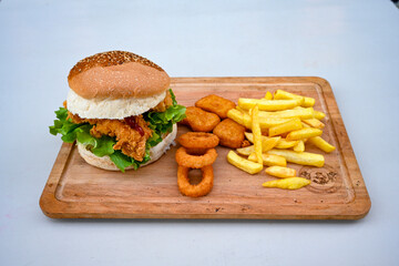 Big tasty burger with beef cutlet on a plate. Hamburger, cheeseburger with mushroom. Hamburger, Mexica, mushroom double burger.  Crispy chicken burger. With french fries, patates kizartmasi.