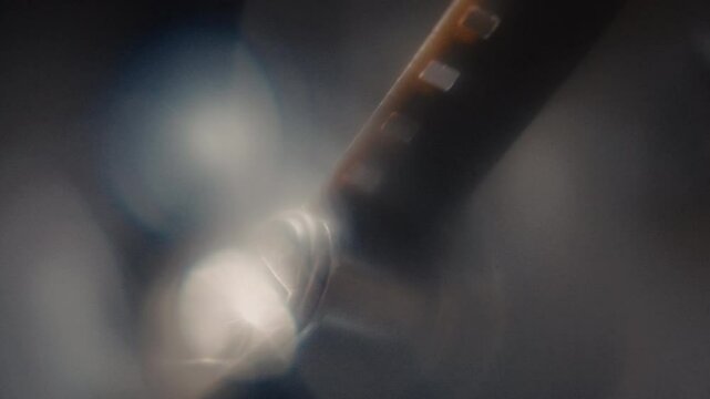 Close ups of a vintage 8MM projector spools moving and playing film 